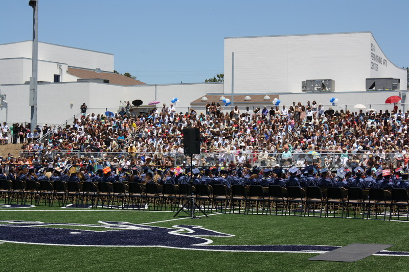 Family and friends crowd the new stadium to watch the seniors graduate. audience