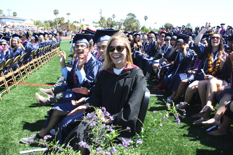 Seniors cheer down their classmates as they walk down the aisle. down-aisle-2