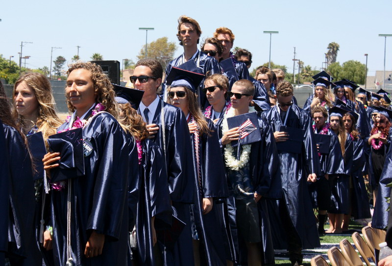 Students stand up for the national anthem. hand-over-hearts