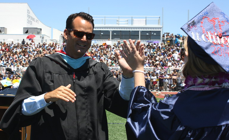 Principal Timothy Hornig gives students high fives as they walk to their seats. hornig