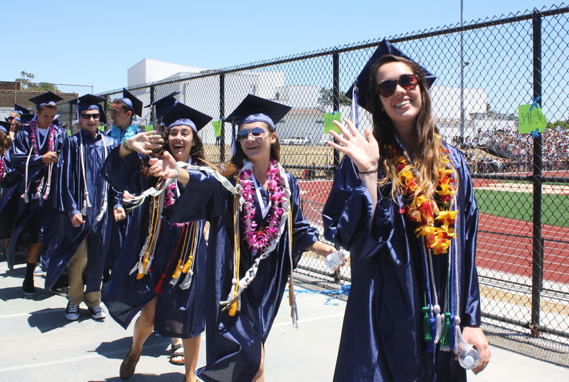 Students leave the tennis courts to begin walking to their seats. journalism