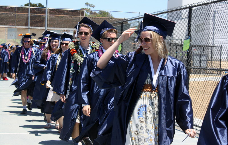 Students leave the tennis courts to begin walking to their seats. people-walking