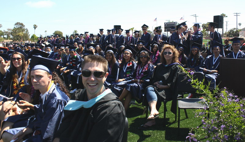 Teachers and students cheer as seniors walk down the aisle. witt