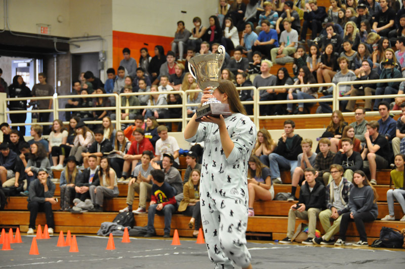 MC Tara Gildersleeve shows off a trophy won by the boys basketball team 9