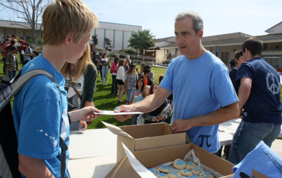 A+student+recieves+the+prize+package+from+math+teacher+Paul+Brice+after+reciting+the+required+number+of+pi+digits.