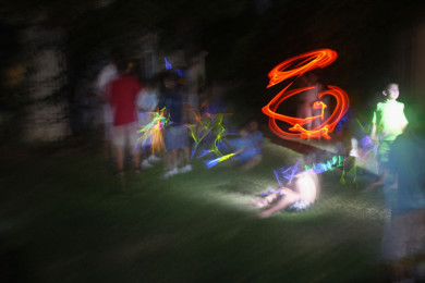 Neighborhood kids play with glowsticks during the power outage.