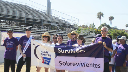 Cancer survivors take a walk around the track, known as the Survivor lap.