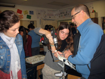 Orthopedic surgeon Joel Smith assists Juniors Kate Shapiro and Allison Sakihara in fixing a broken bone.