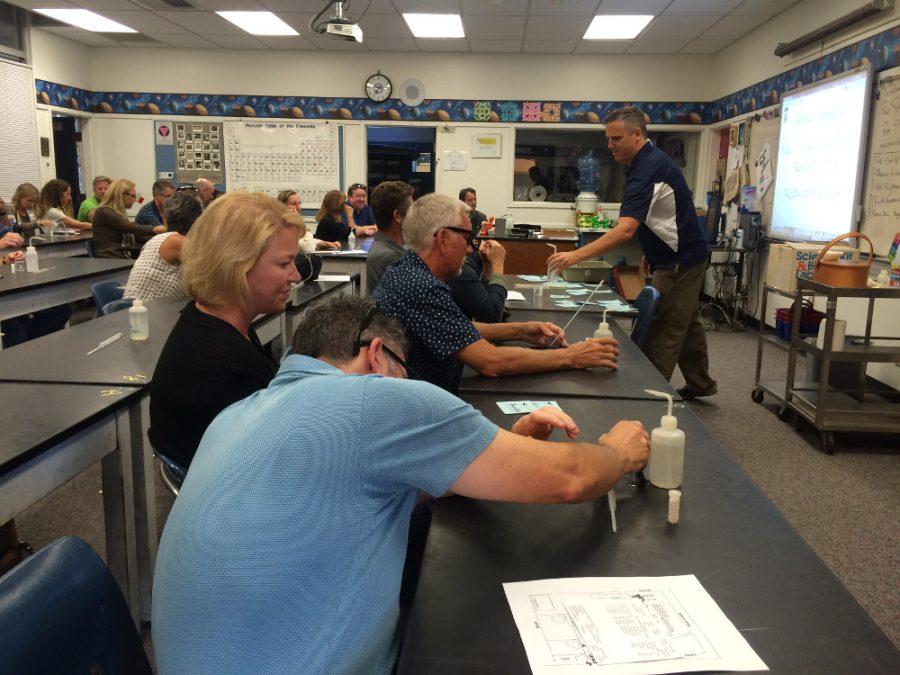 Parent's attending a period in Davidson's classroom on Back to School Night, performed their own short experiments.