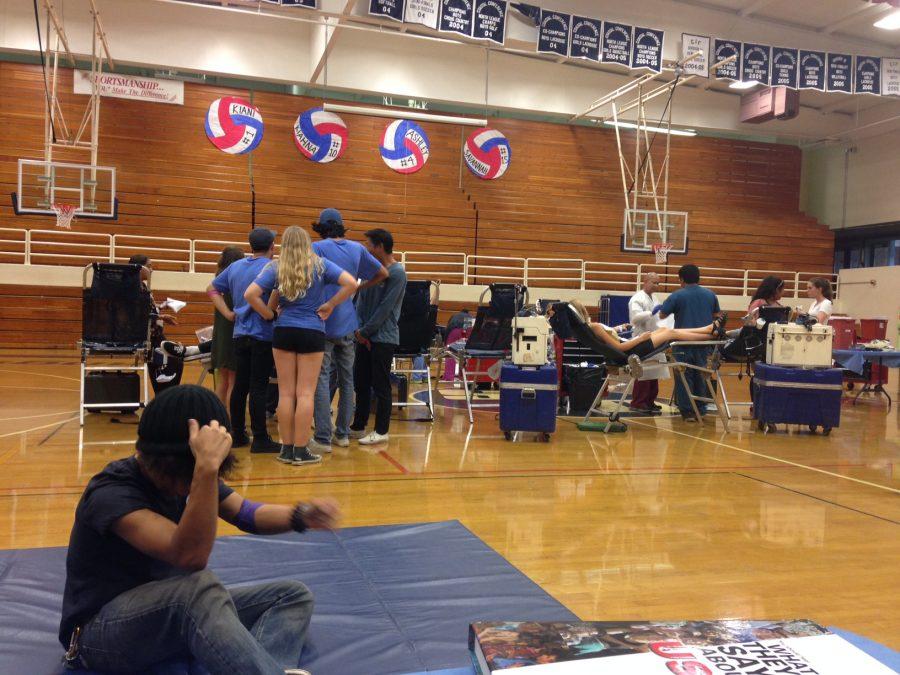 SDA+students+left+class+to+donate+blood+in+the+gym.