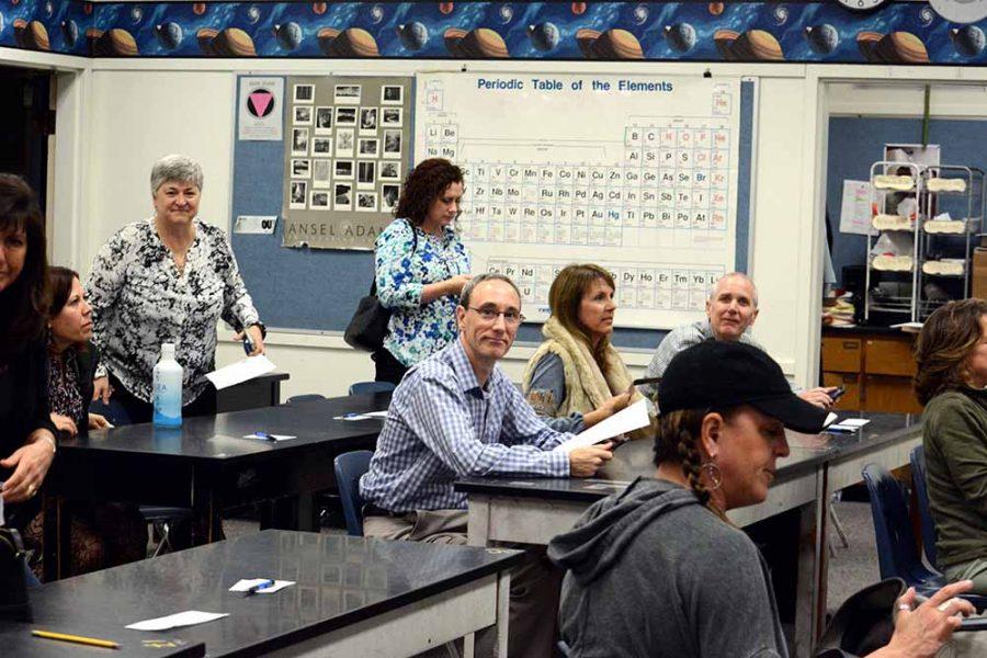 Parents arrive in chemistry teacher Russ Davidson's classroom to learn about the class.