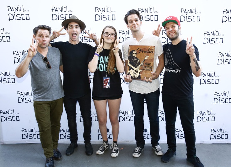 Sophomore Mackinsey Creagan posing with rock band Panic! at the Disco.