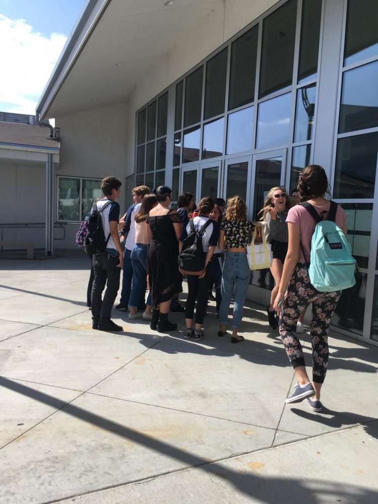Students gather around the cast list of "Calvin Berger"
