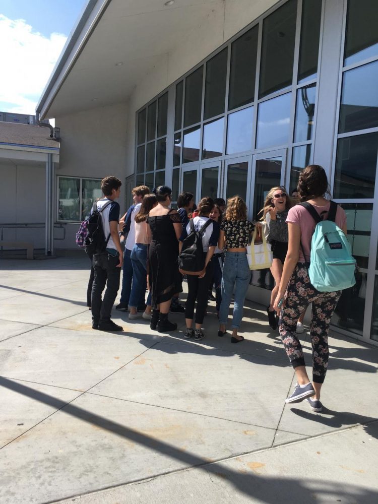 Students gather around the cast list of Calvin Berger