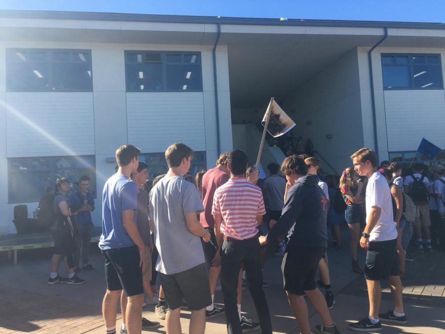 Students gather with their homeroom flag at the most recent Homeroom Olympics event.