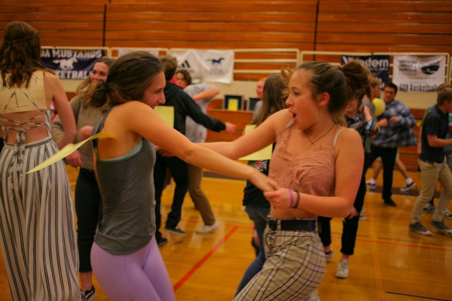 Juniors Adriana Billante and Kiomi Yamada jam to the music during last week's homeroom dance party.