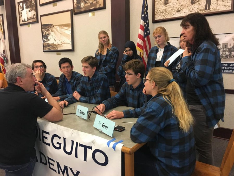 The Varsity Mustang Minds team meets with their mediator before the match.