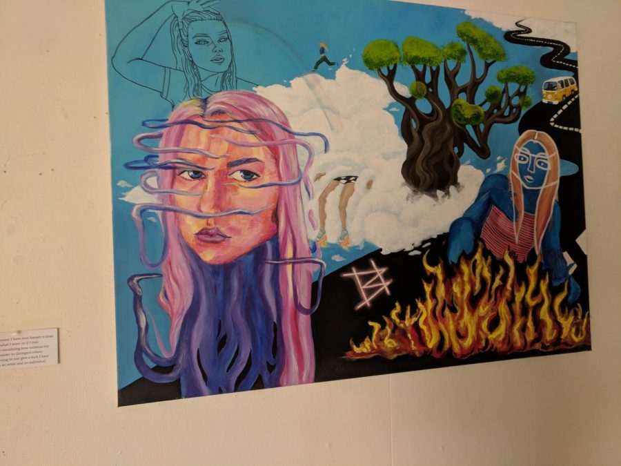 The gallery displays art by students and focuses on themes related to womanhood, including this piece by junior Bridget Brightfield.