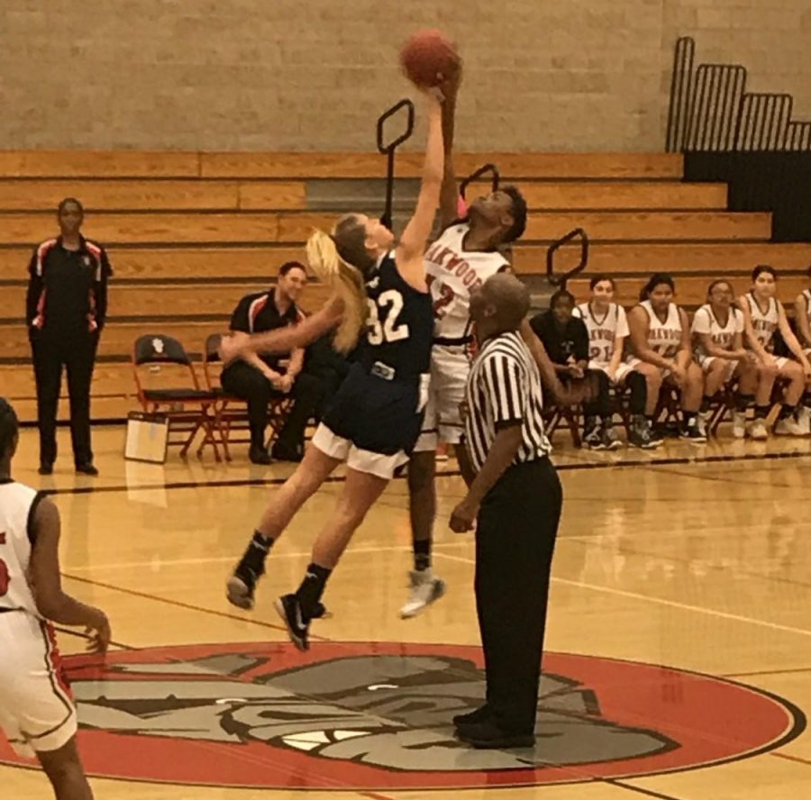 The SDA girls basketball team competes with Oakland to get the jump ball.