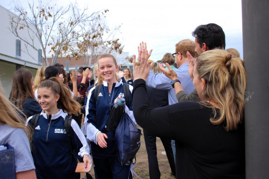 Students+gathered+to+wish+the+girls+basketball+team+good+luck.