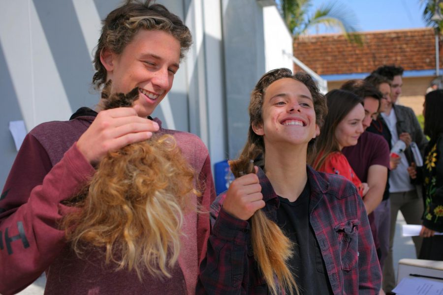 Freshman Walker Mayer and sophomore Shawlin Tucker show off their new hair.