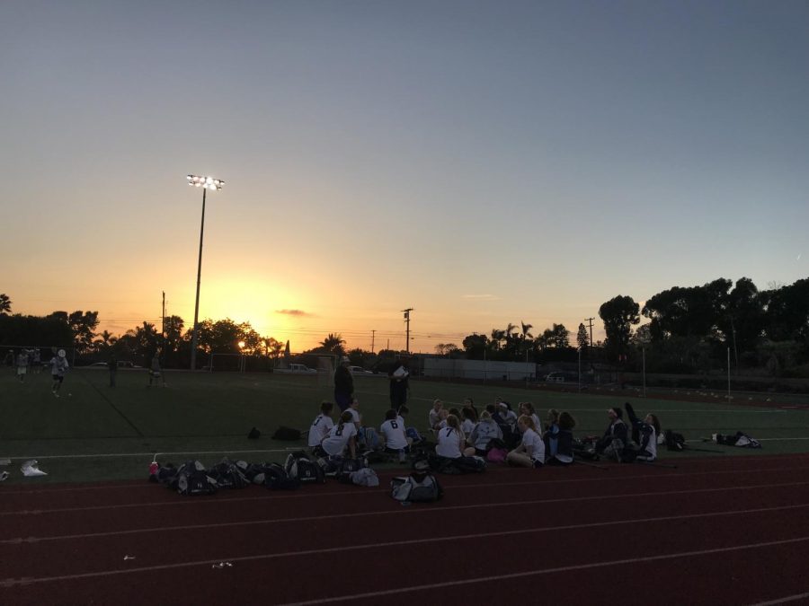 The lacrosse team huddles up to discuss their big win.