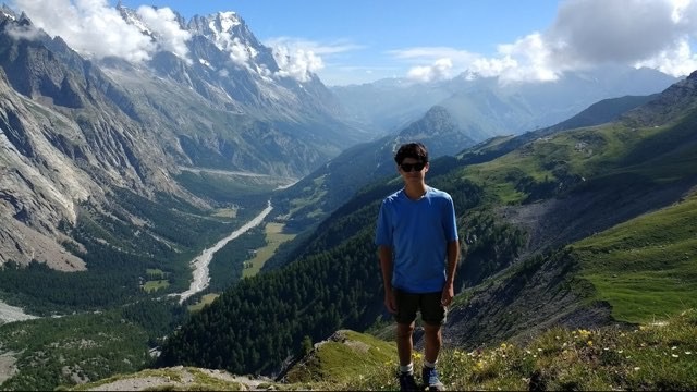 Aiden Baker poses in front of the world renowned valleys of the Swiss Alps.