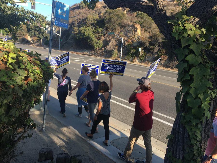 SDFA members carried signs promoting their three endorsed candidates during a demonstration last Thursday. 