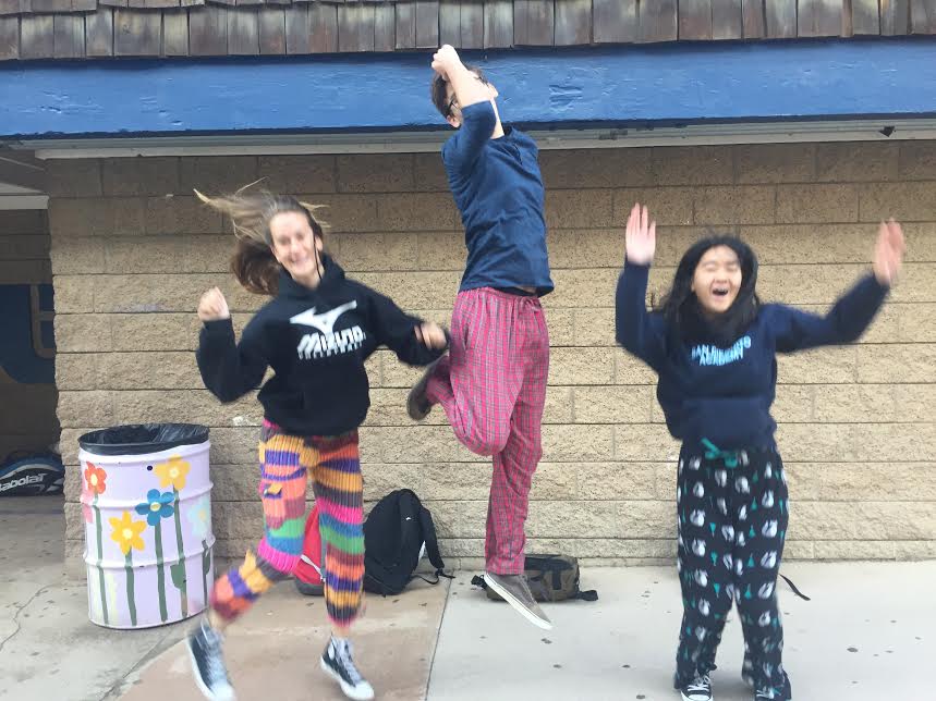 Students jump for joy in their sleepwear.