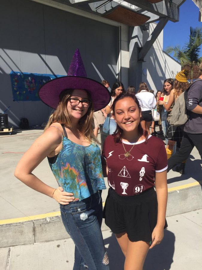 Sophomores Phoebe Kreps and Ellery Bolton in front of the butter beverage stand.