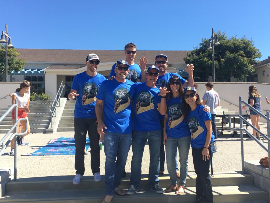 Teachers Collin Elliott, Eli Cameron, James Hrzina, Jeremy Wright, Oly Norris, Ellen diCristina, and Kerry Koda wearing matching Taco Cat shirts.