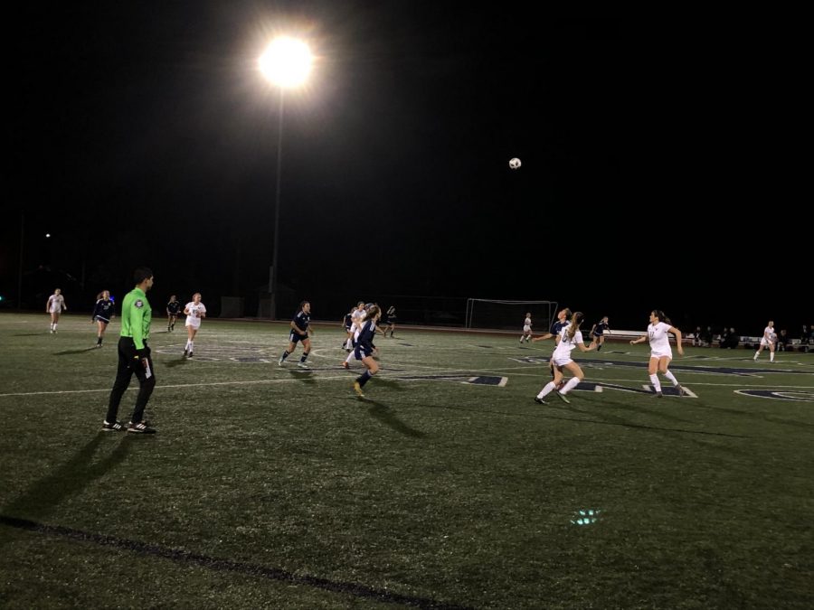 With the ball in the air, players wait impatiently for it to fall back down and continue the game.