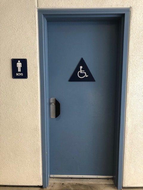 The boy's restroom in the new building has been closed due to vandalism.