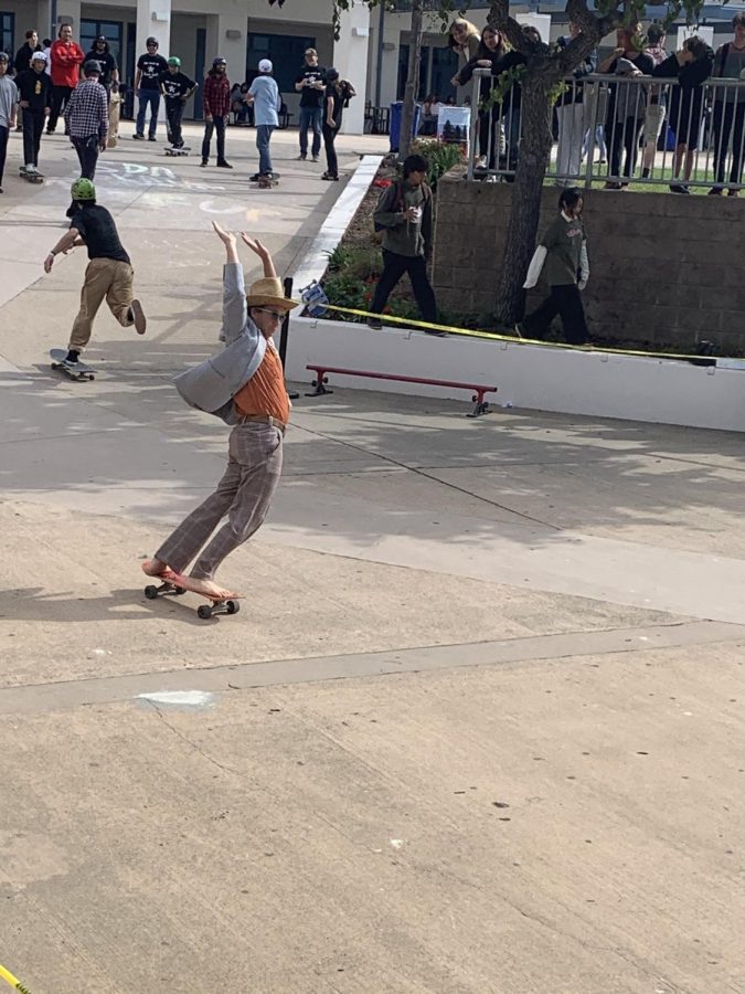 Art teacher Jeremy Wright participates in the Skate Demo.