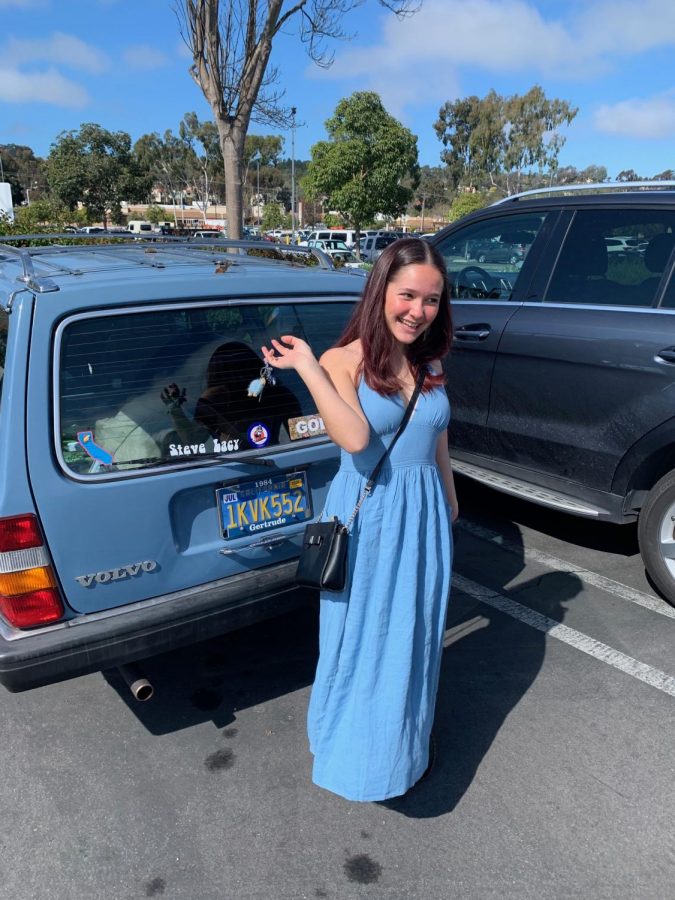 Junior Amelia Armstrong matches her car in a baby blue dress.