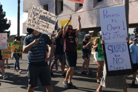 Protestors hold up signs such as 'Recess Is Over! Let's get Back to Class! SDUHSD Has NO Class!' and more in front of the SDUHSD building