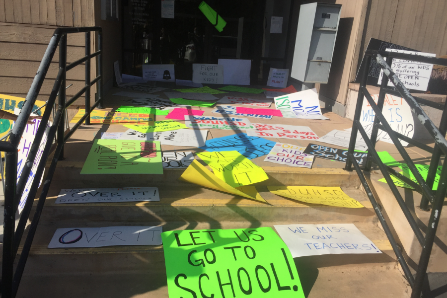 People leave signs in front of the district office with messages like Let us go to school! 