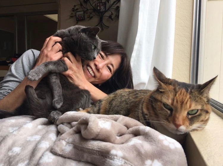 Japanese teacher Rie Tsuboi with her cats Shun (left) and Momo (right) which is a Chinese/Japanese character that means really fast