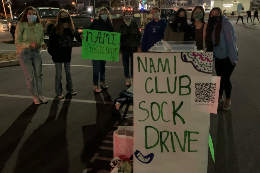 The NAMI club in front of the sick drop off station with signs. 