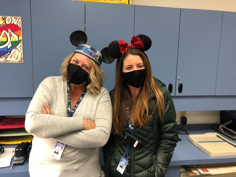 Administrative Assistant Jennifer Beales (left) and Administrative Assistant Rachel Miller (right) with Micky headbands