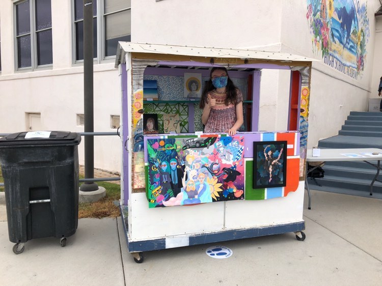 A girl in a cart with art