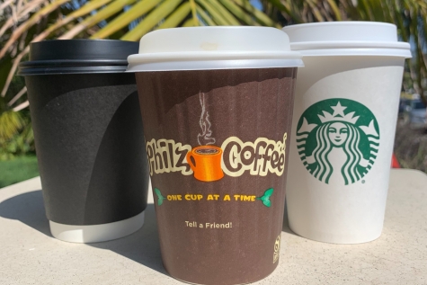Black cup, brown cup, and white cup lined in a row