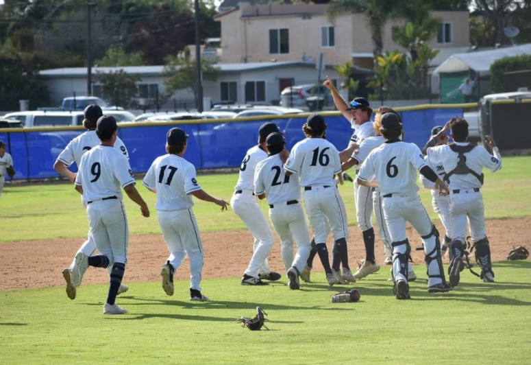 Baseball players celebrate on the Don Crickmore field