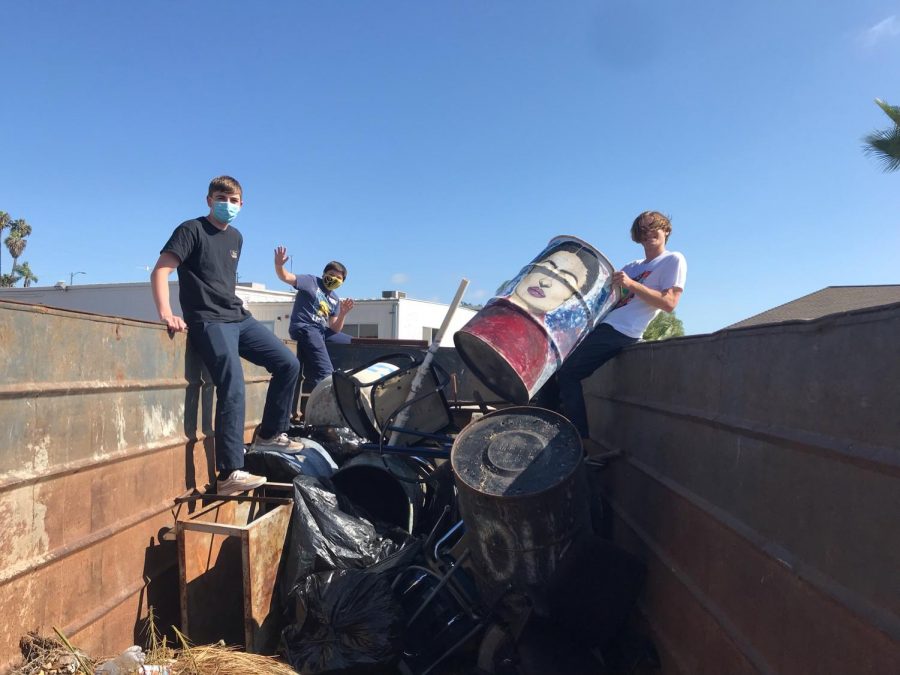 Three SDA students help Max Vennemeyer  rescue the Frida Kahlo trash can.