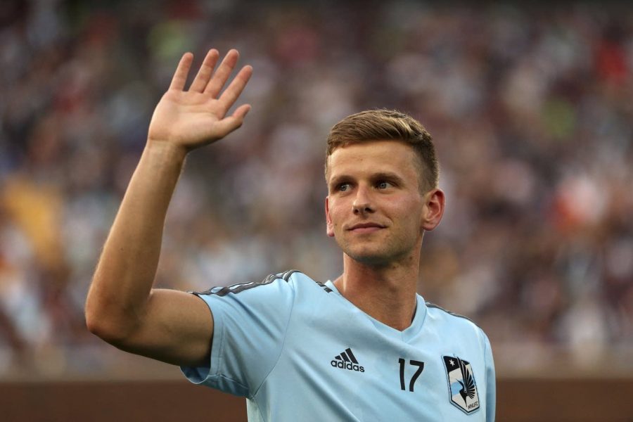 Collin Martin waves to stands after coming out earlier in the day