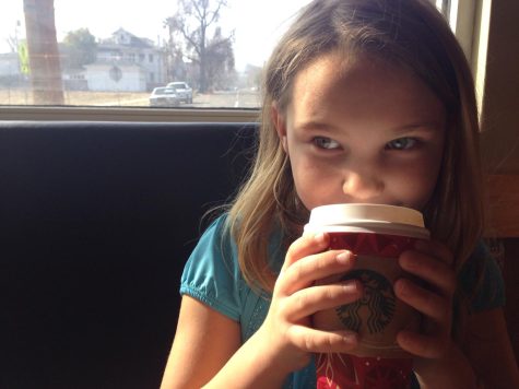 Mischievous girl sips Starbucks drink