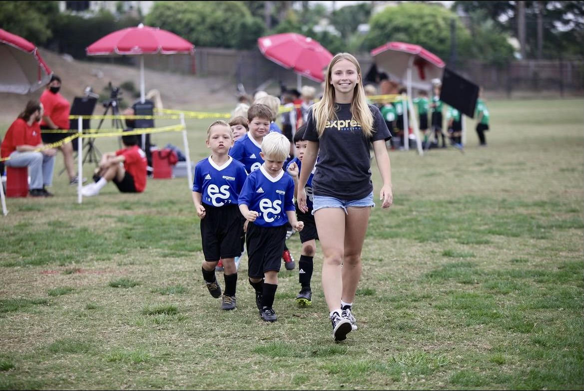 SDA Student and coach Kira Sage leads her Encinitas Express recreational team through picture day