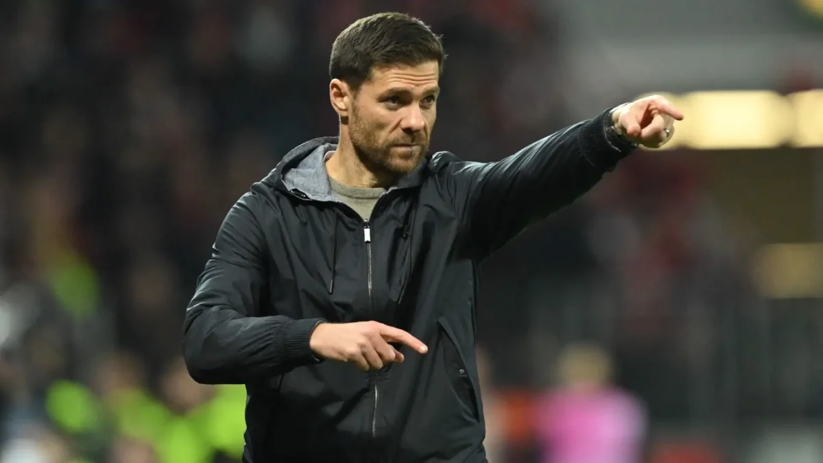 Xabi Alonso directs players of his former club, Bayer Leverkusen, during a match